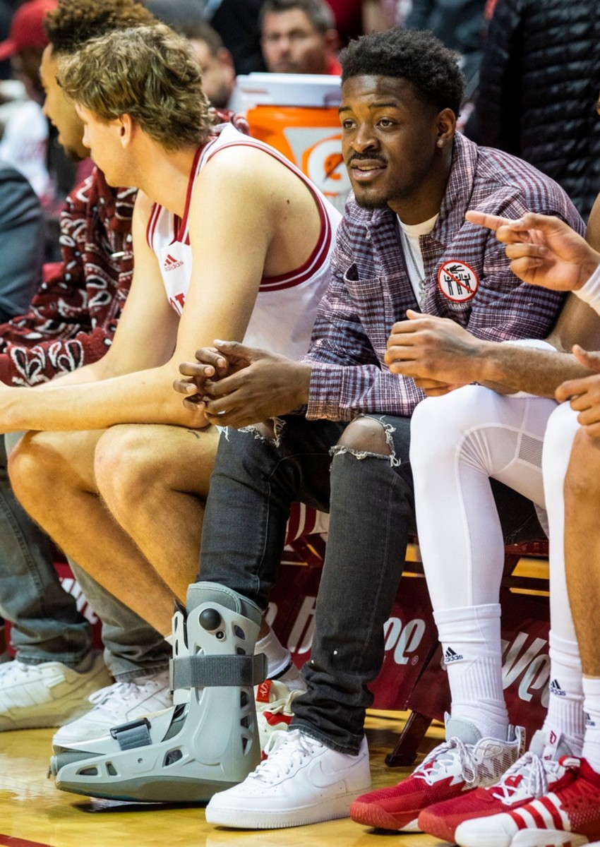 Indiana senior Xavier Johnson sits on the bench at Assembly Hall with a boot on his right foot. (Rich Janzaruk/Herald-Times / USA TODAY NETWORK)