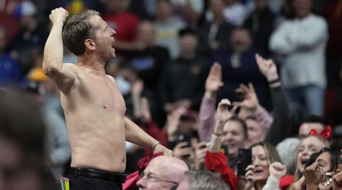 Arkansas head coach Eric Musselman celebrates with fans after beating Kansas.