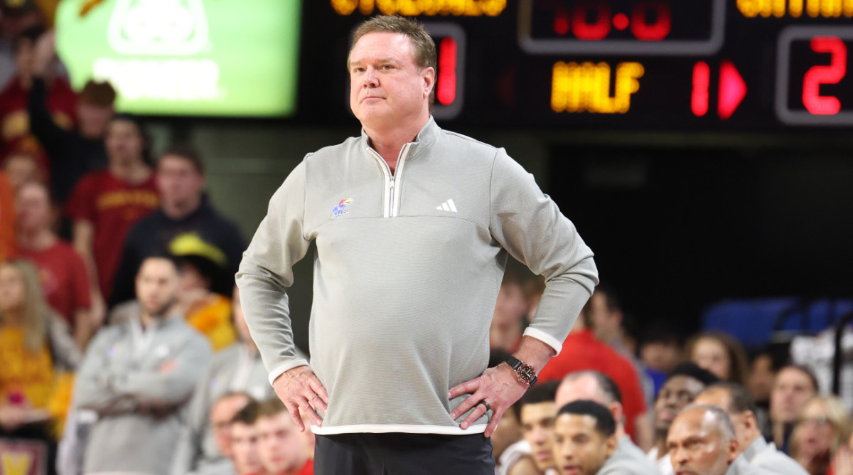 Kansas men’s basketball coach Bill Self stands with his hands on his hips.
