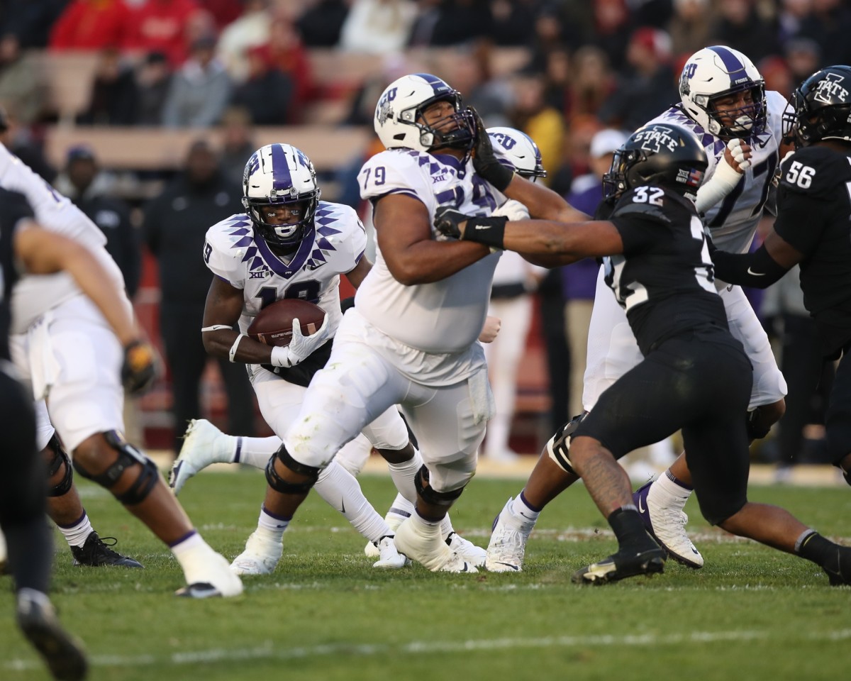 Nov 26, 2021; Ames, Iowa, USA; TCU Horned Frogs wide receiver TJ Steele (19) runs behind blocker TCU Horned Frogs center Steve Avila (79) against the Iowa State Cyclones at Jack Trice Stadium. Mandatory Credit: Reese Strickland-USA TODAY Sports
