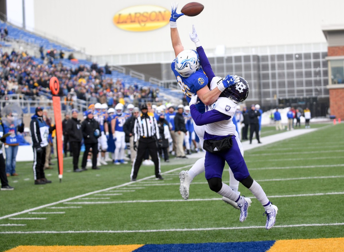 South Dakota State s Tucker Kraft leaps to catch a pass in the end zone as Holy Cross John Smith prevents him from doing so in the FCS quarterfinals on Saturday, December 10, 2022, in Sioux Falls. Fcs Quarterfinal 003