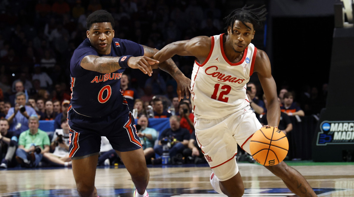 Houston guard Tramon Mark (12) drives to the basket around Auburn guard K.D. Johnson