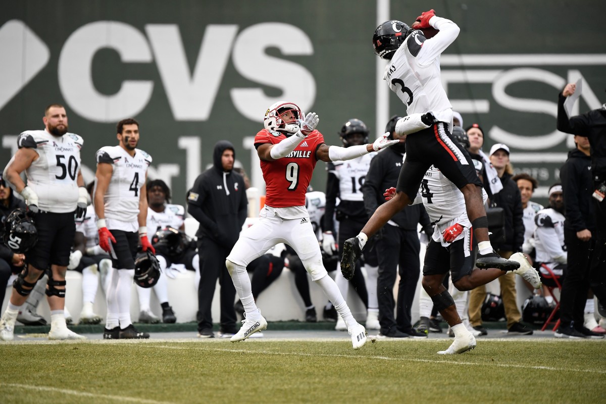 Dec 17, 2022; Boston, MA, USA; Cincinnati Bearcats safety Ja'von Hicks (3) intercepts a pass intended for Louisville Cardinals wide receiver Ahmari Huggins-Bruce (9) during the second half at Fenway Park. Mandatory Credit: Eric Canha-USA TODAY Sports