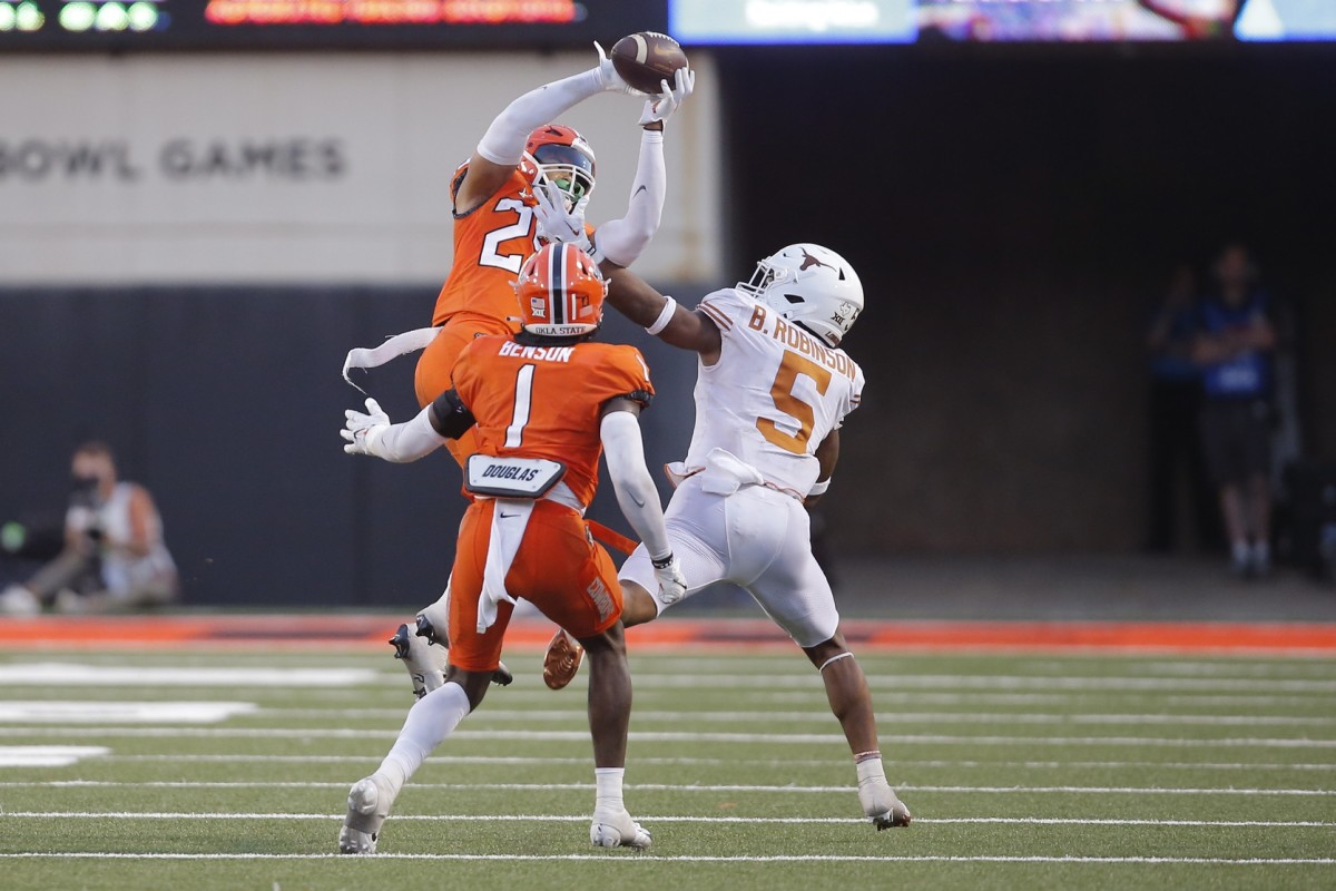 Oct 22, 2022; Stillwater, Oklahoma, USA; Oklahoma State Cowboys safety Jason Taylor II (25) intercepts a pass intended for Texas Longhorns running back Bijan Robinson (5) during a game at Boone Pickens Stadium. Mandatory Credit: Bryan Terry/The Oklahoman via USA TODAY NETWORK
