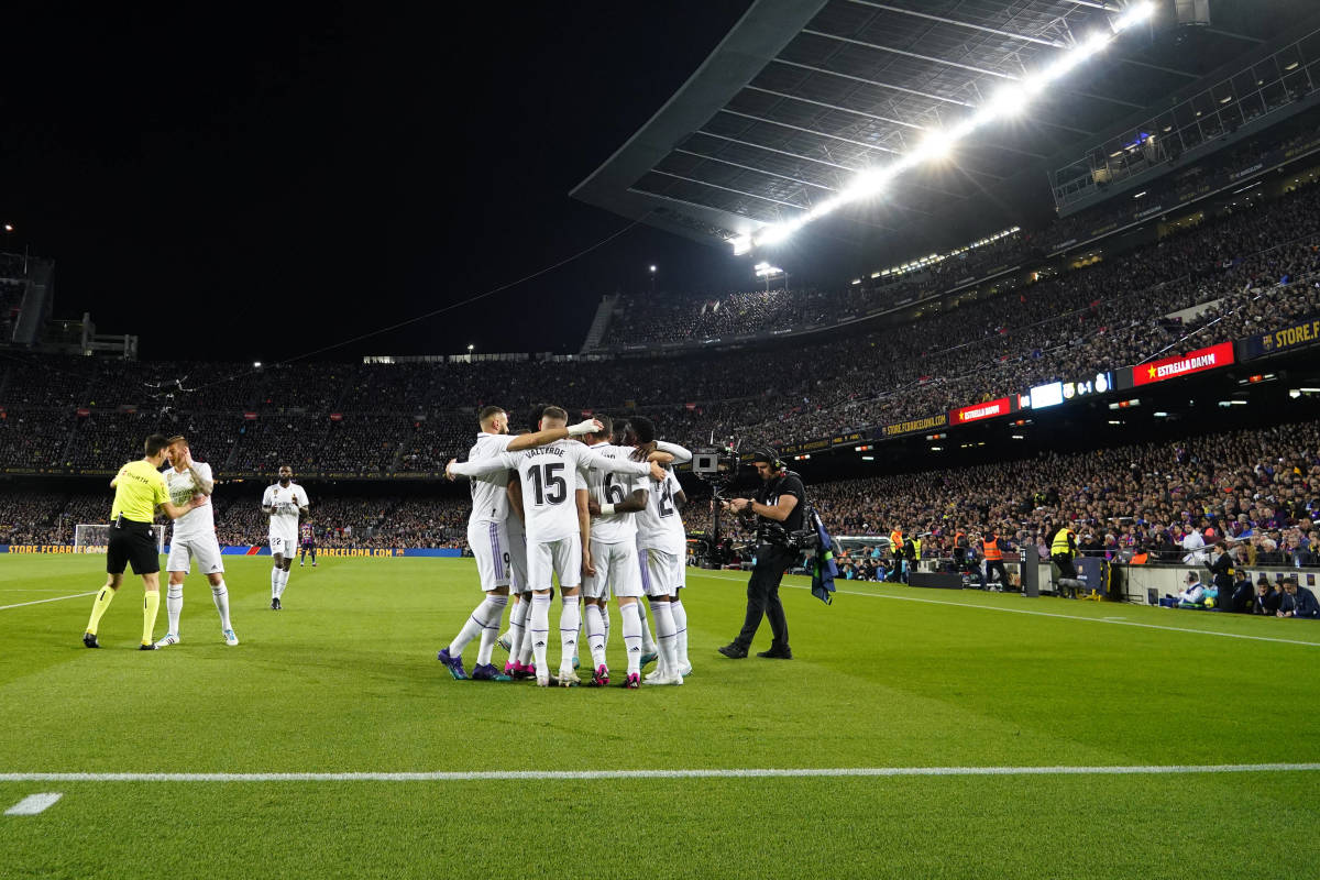 Players from Real Madrid pictured celebrating after an own goal scored by Barcelona defender Ronald Araujo (not in shot) during a Clasico in March 2023