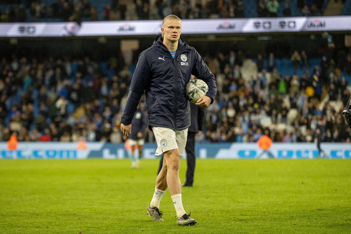 Erling Haaland pictured leaving the field with the match ball after scoring a hat-trick in Manchester City's 6-0 win over Burnley in March 2023
