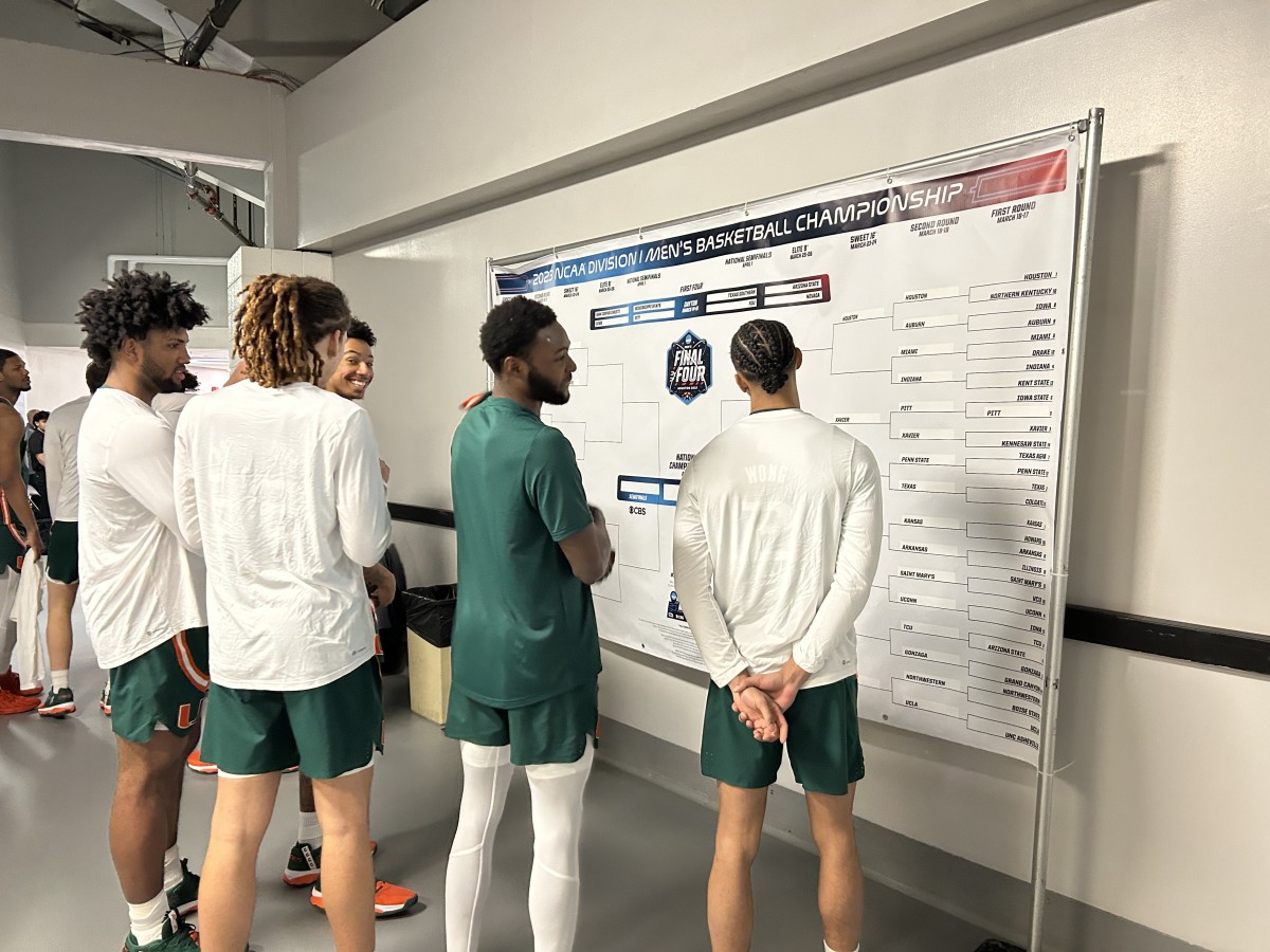Miami players check out the bracket before heading out to the floor on Sunday night.