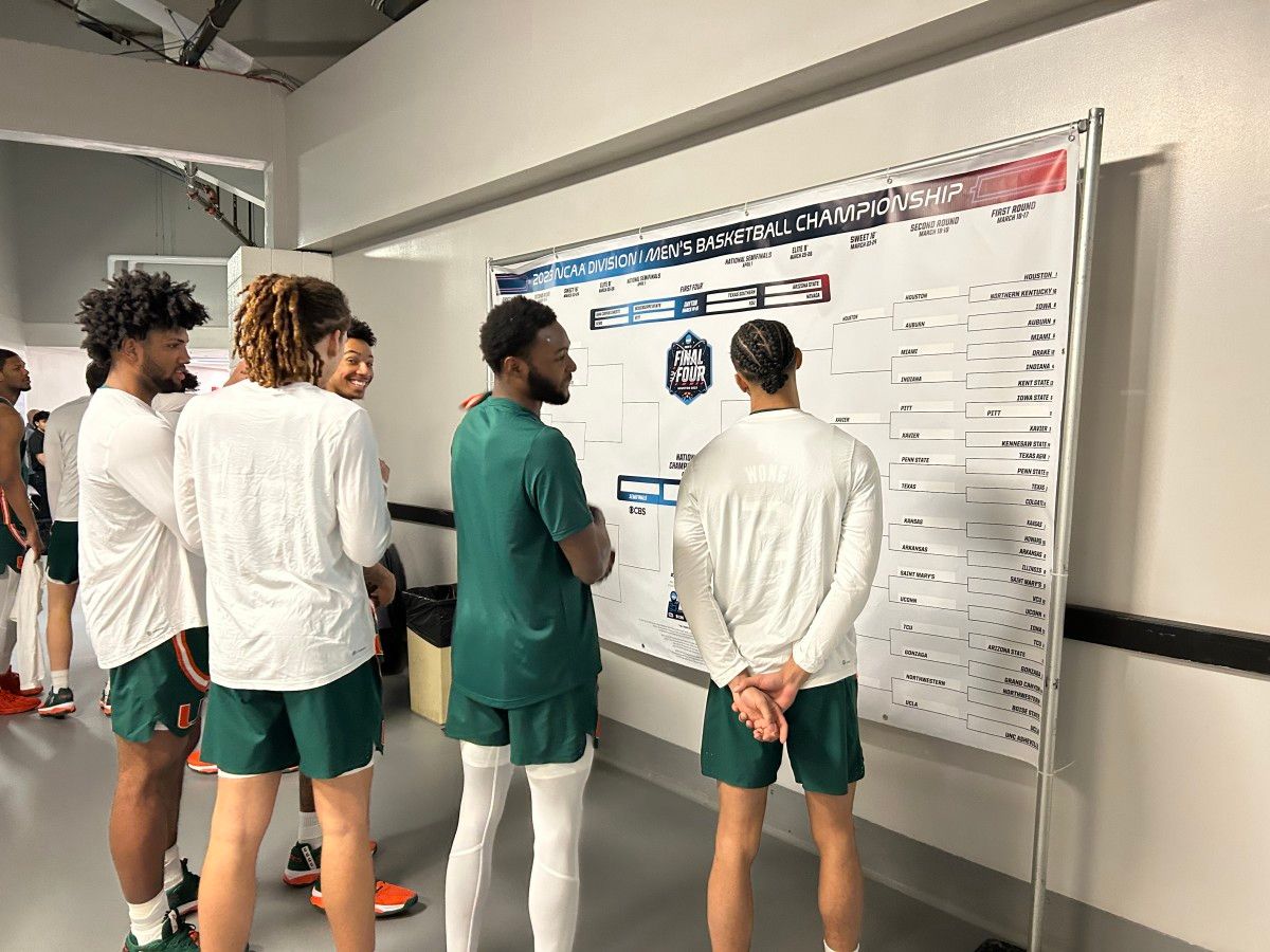 Miami players check out the bracket before heading out to the floor on Sunday night.