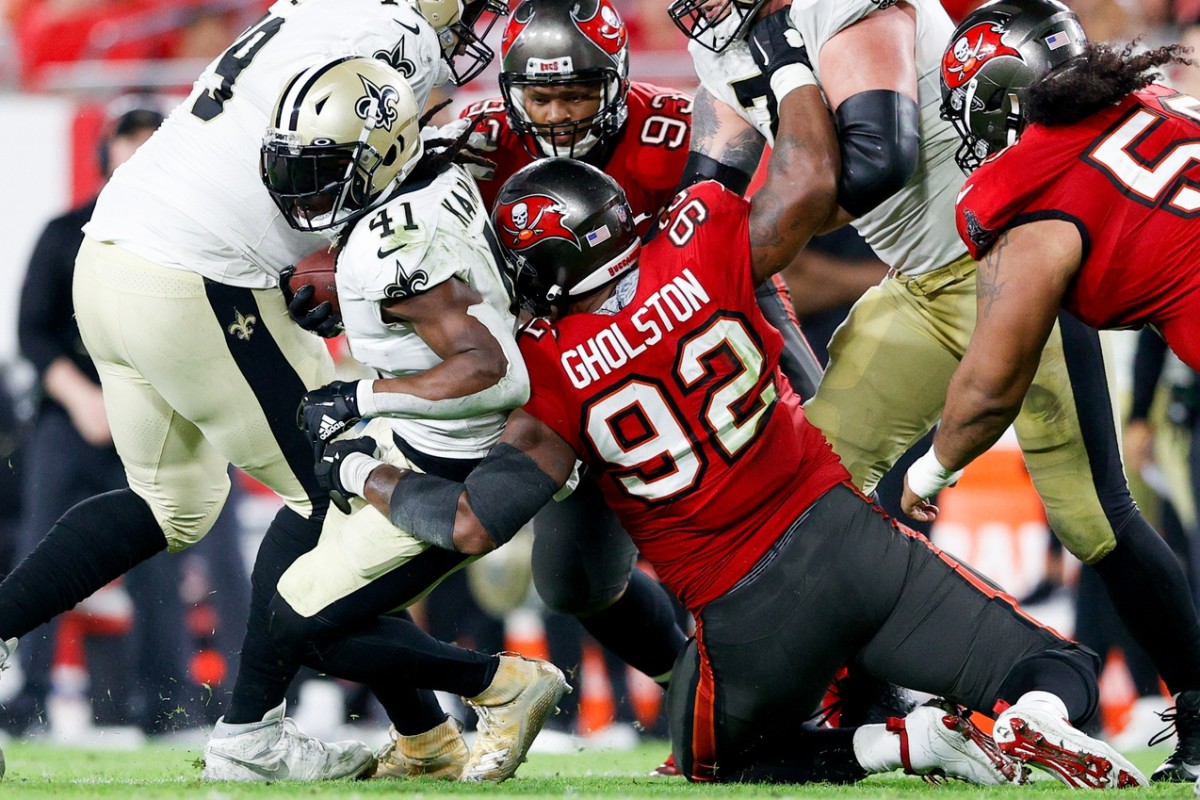 Dec 19, 2021; New Orleans Saints running back Alvin Kamara (41) is tackled by Tampa Bay Buccaneers defensive end William Gholston (92). Mandatory Credit: Nathan Ray Seebeck-USA TODAY