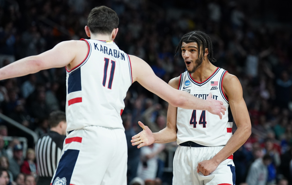 Conn Huskies guard Andre Jackson Jr. and forward Alex Karaban reach for a high five