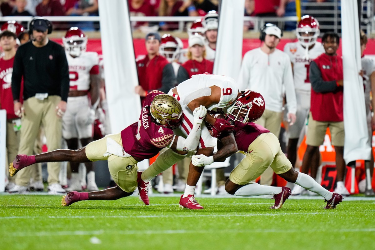 Dec 29, 2022; Orlando, Florida, USA; Florida State Seminoles linebacker Kalen DeLoach (4) tackles Oklahoma Sooners tight end Brayden Willis (9) during the first quarter in the 2022 Cheez-It Bowl at Camping World Stadium. Mandatory Credit: Rich Storry-USA TODAY Sports