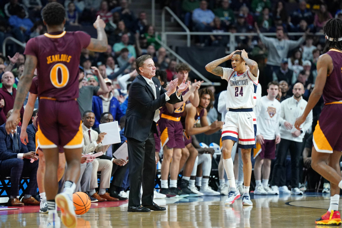 head coach Rick Pitino and UConn Huskies guard Jordan Hawkins both react to a play on the sidelines