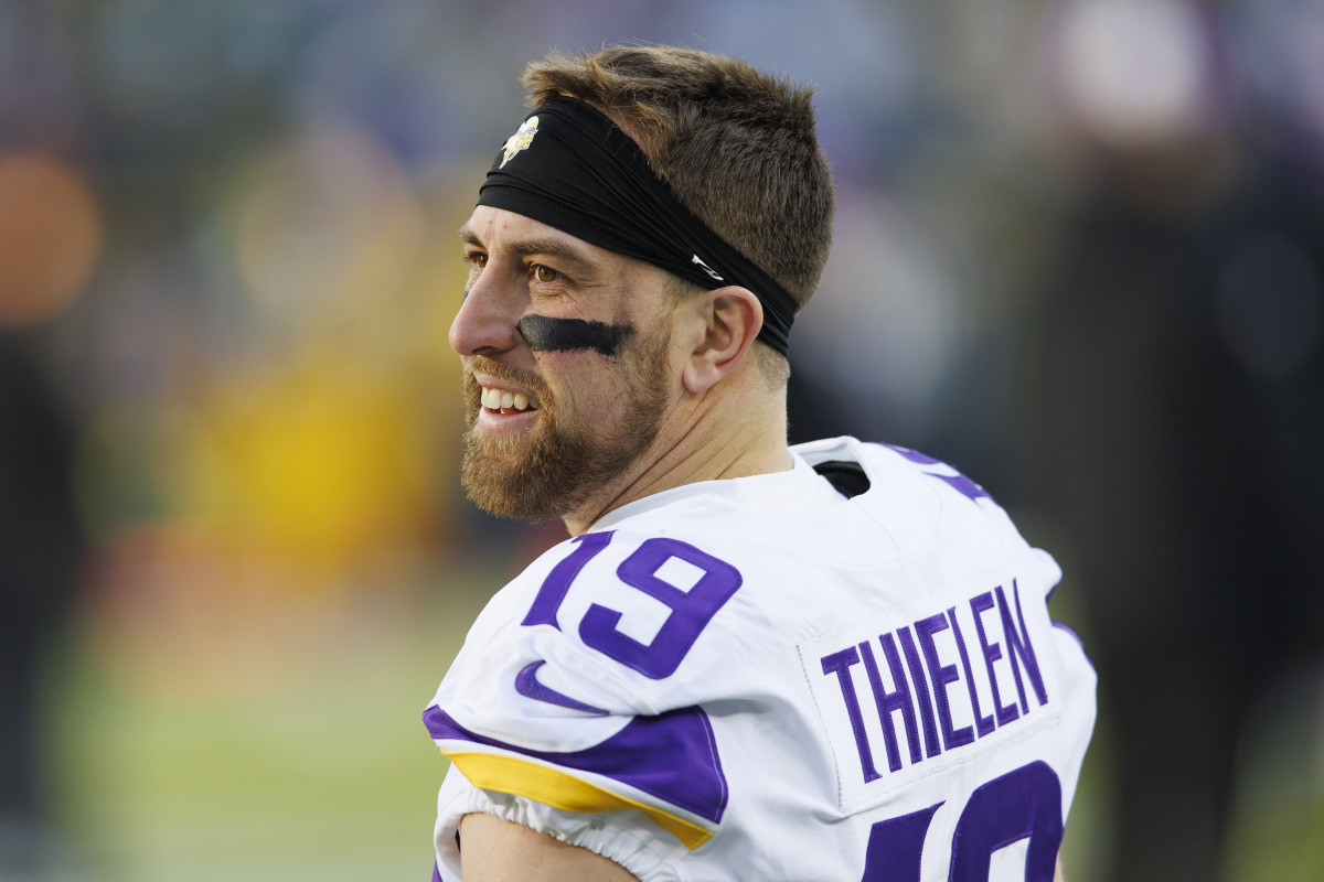 Wide receiver Adam Thielen smiles and looks to the side in a Vikings uniform, no helmet on
