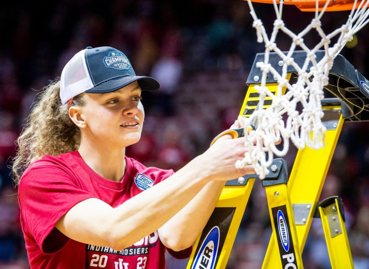 Indiana's Grace Berger (34) cuts down part of the net after the second half of the Indiana versus Purdue women's basketball game at Simon Skjodt Assembly Hall on Sunday, Feb. 19, 2023.