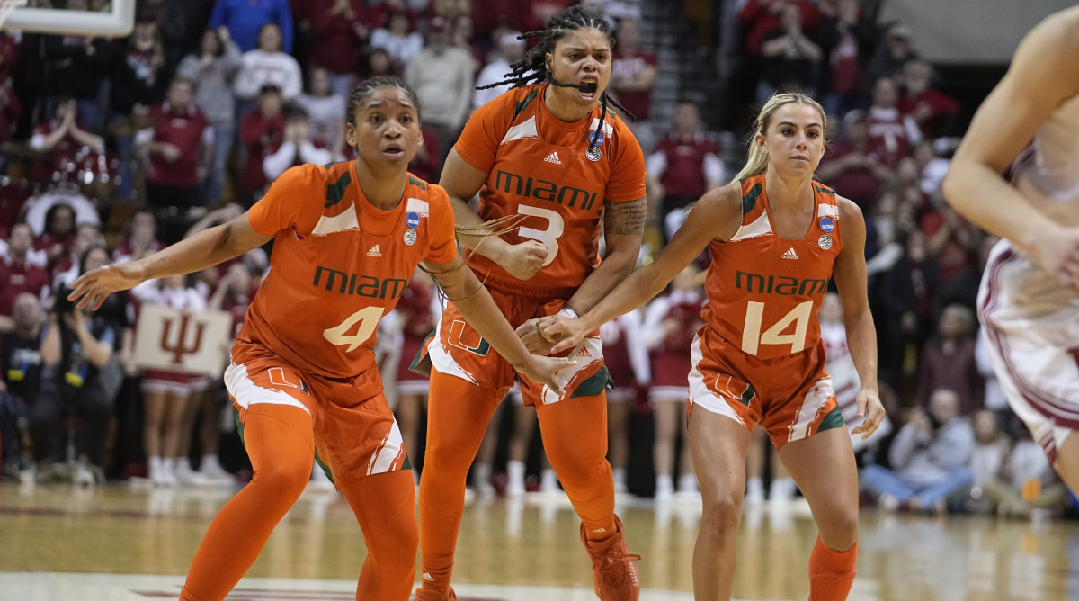 Miami’s Jasmyne Roberts, Destiny Harden and Haley Cavinder  react after Harden hit a late shot to help the Hurricanes beat Indiana in the second round of the NCAA women’s tournament.