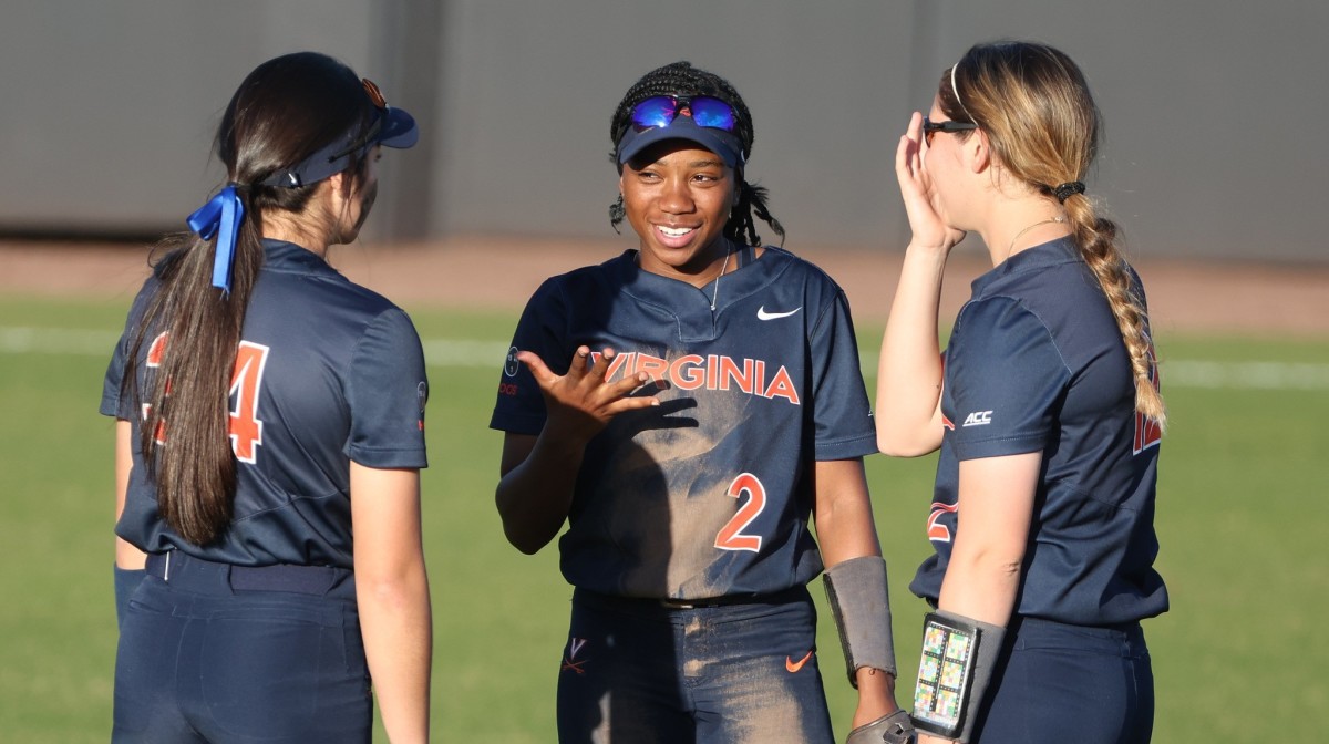 Kailyn Jones talks with her teammates in the outfield during the Virginia baseball game against Radford at Palmer Park.