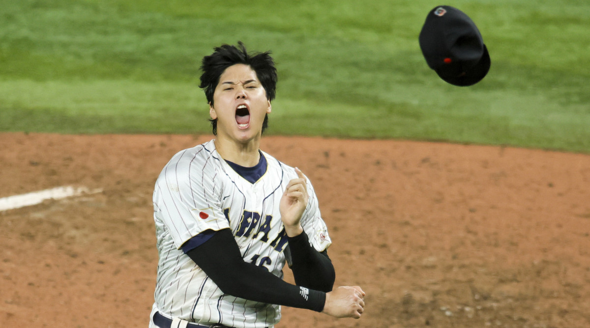 Shohei Ohtani throws his hat in celebration after striking out Mike Trout to win the World Baseball Classic for Japan