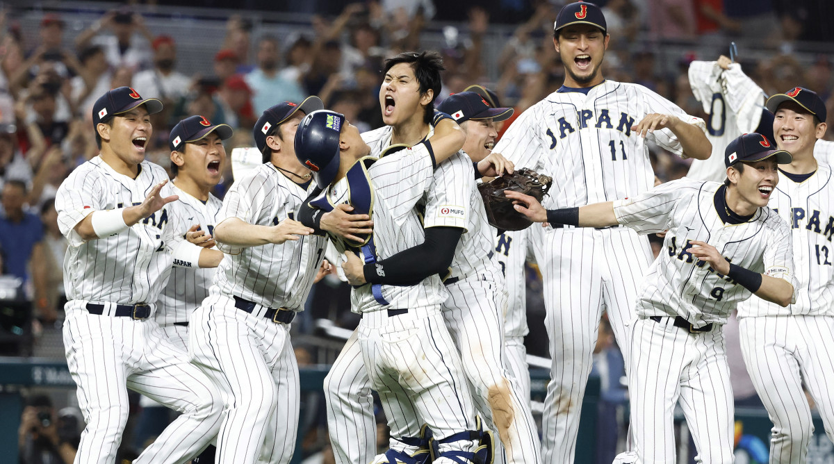 Team Japan crowds around the mound to celebrate World Baseball Classic win