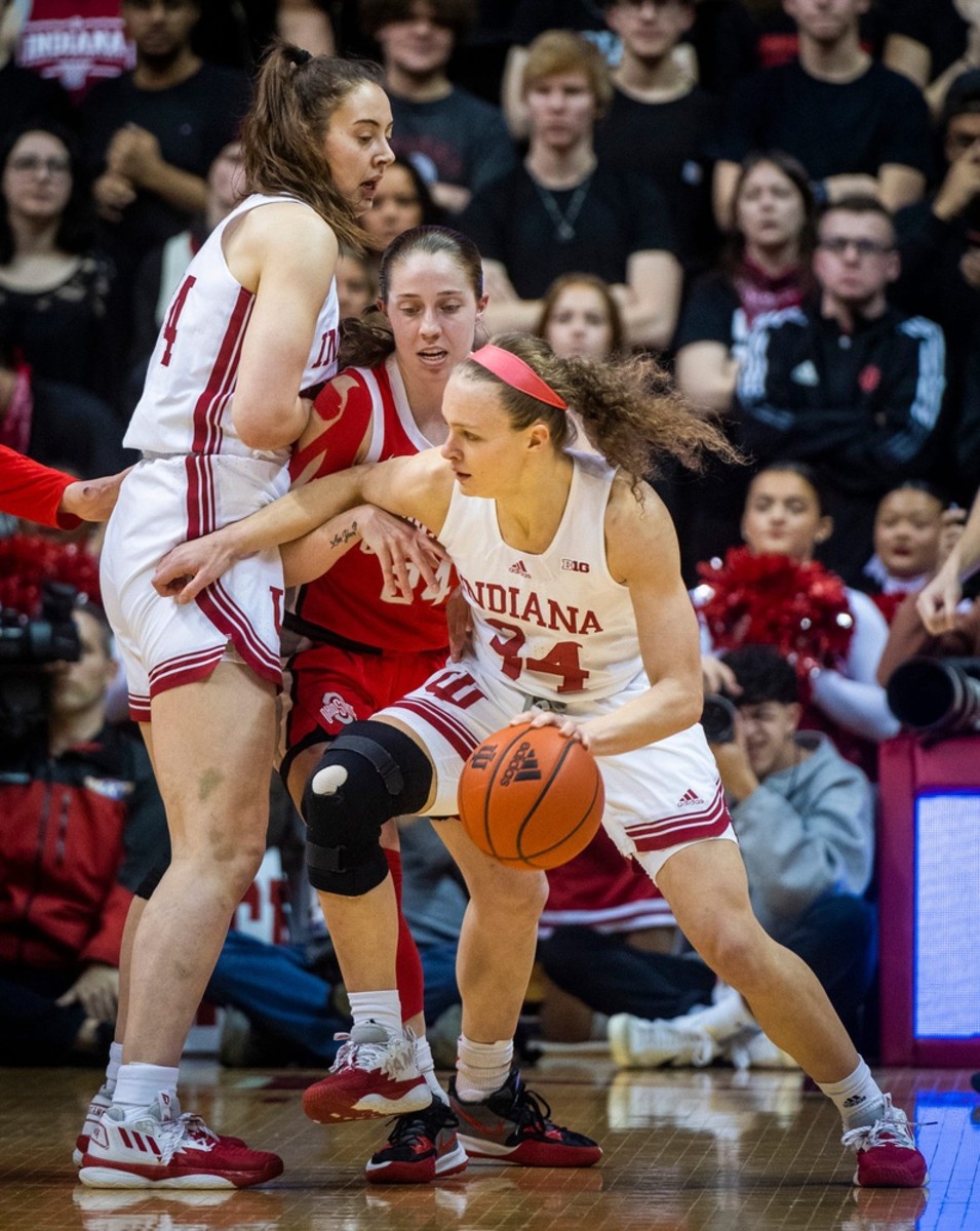 Indiana's Grace Berger (34) uses a screen by Indiana's Mackenzie Holmes (54) to get by Ohio State's Taylor Mikesell (24) during the first half of the Indiana versus Ohio State women's basketball game at Simon Skjodt Assembly Hall on Thursday, Jan. 26, 2023.