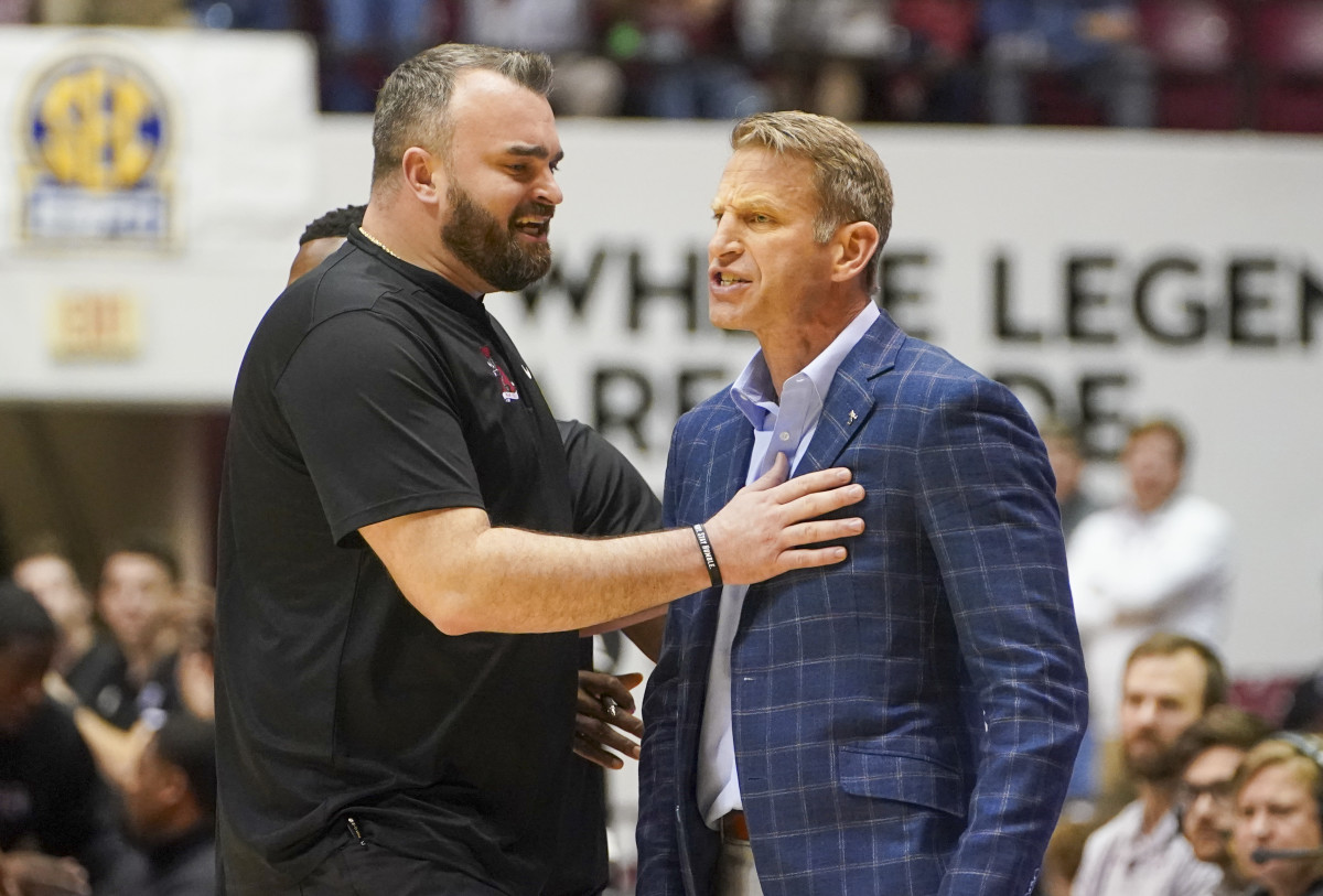 Feb 16, 2022; Tuscaloosa, Alabama, USA; Alabama Crimson Tide assistant coach Bryan Hodgson (left) holds back head coach Nate Oats after receiving a second technical foul during the second half against Mississippi State Bulldogs at Coleman Coliseum.