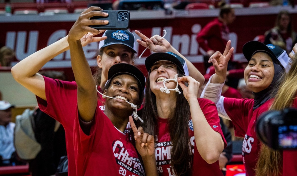 Indiana's Chloe Moore-McNeil (22), front left, Yarden Garzon (12), top left, Mona Zaric (24), front right, and Kiandra Browne (23), right pose for a selfie with their parts of the net after the second half of the Indiana versus Purdue women's basketball game at Simon Skjodt Assembly Hall on Sunday, Feb. 19, 2023.