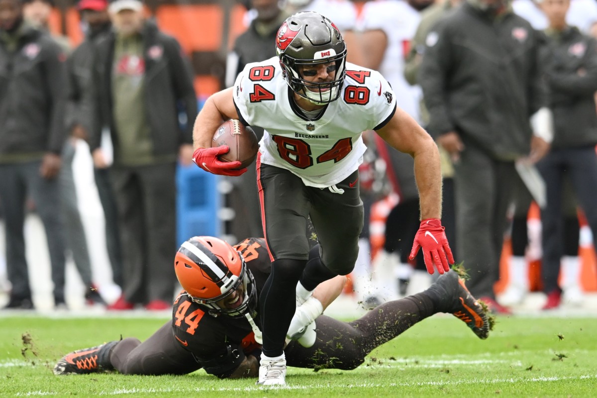 Nov 27, 2022; Cleveland, Ohio, USA; Tampa Bay Buccaneers tight end Cameron Brate (84) breaks the tackle of Cleveland Browns linebacker Sione Takitaki (44) during the first half at FirstEnergy Stadium. Mandatory Credit: Ken Blaze-USA TODAY Sports
