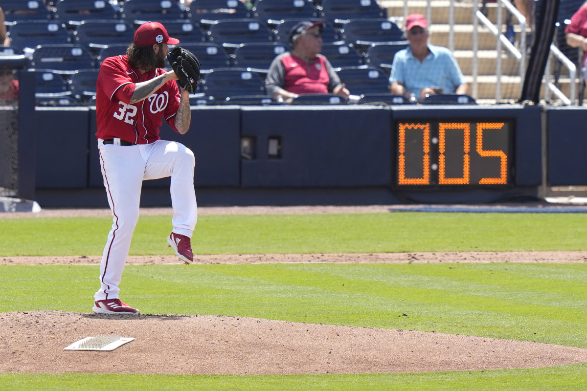 Nationals starting pitcher Trevor Williams winds up to throw as the pitch clock runs during the fourth inning of a spring training baseball game.