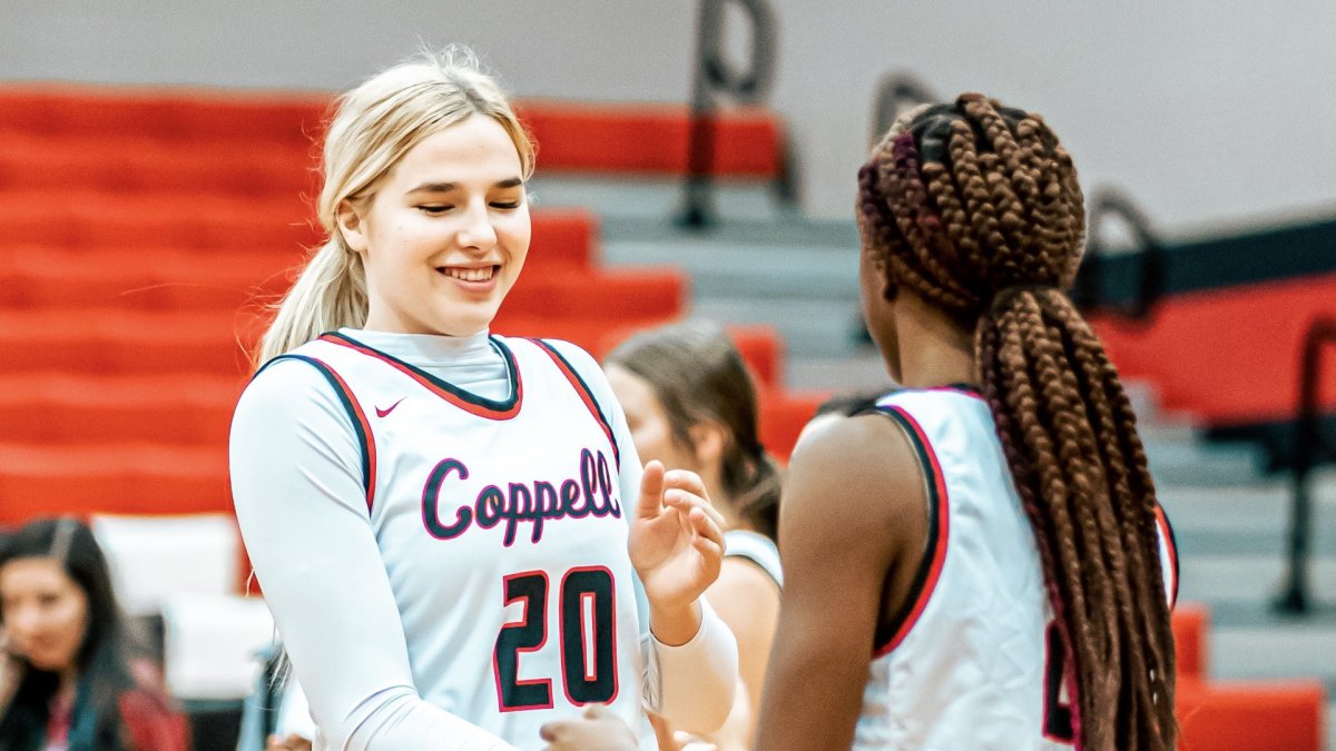 Julianna LaMendola greets her teammate during a Coppell High School basketball game.