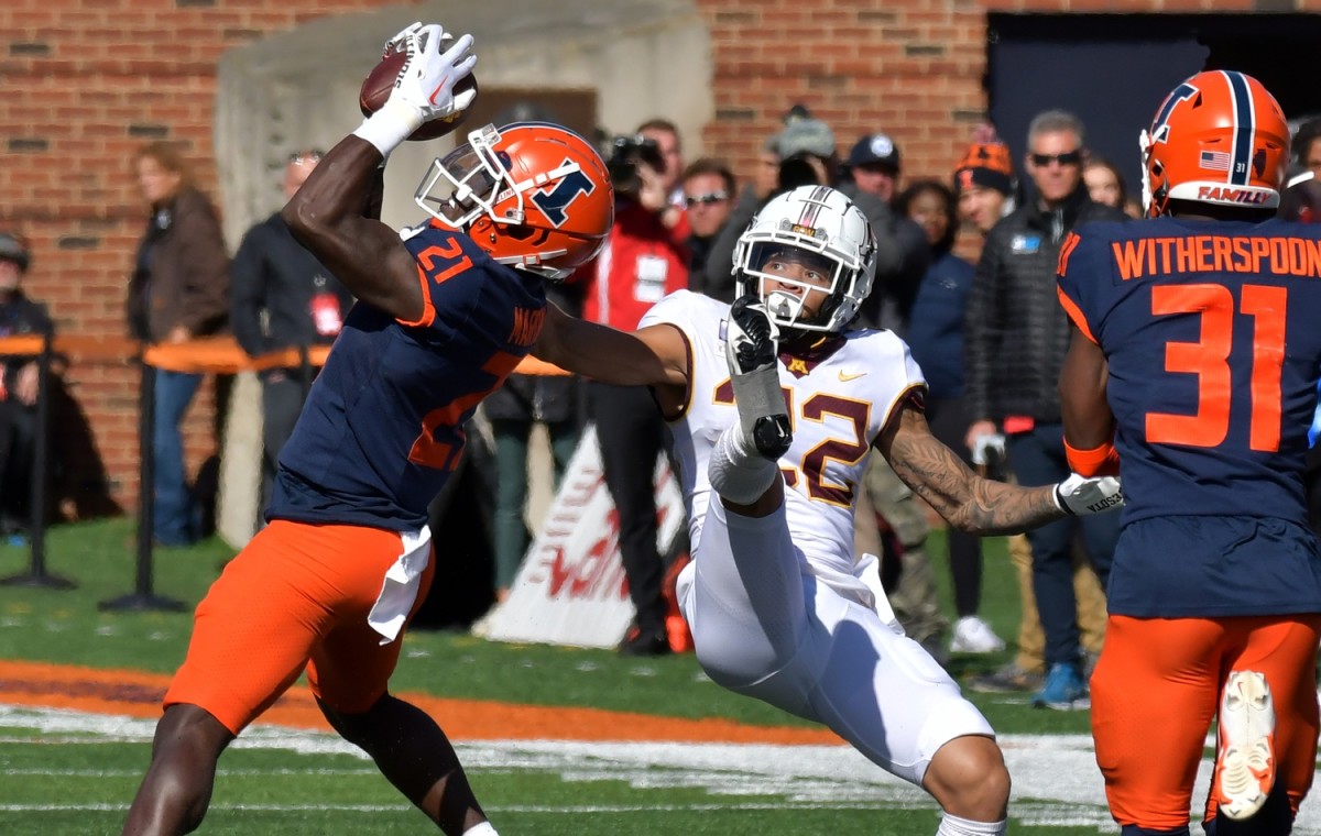 Oct 15, 2022; Champaign, Illinois, USA; Illinois Fighting Illini defensive back Jartavius Martin (21) intercepts the ball intended for Minnesota Golden Gophers wide receiver Michael Brown-Stephens (22) during the second half at Memorial Stadium. Mandatory Credit: Ron Johnson-USA TODAY Sports
