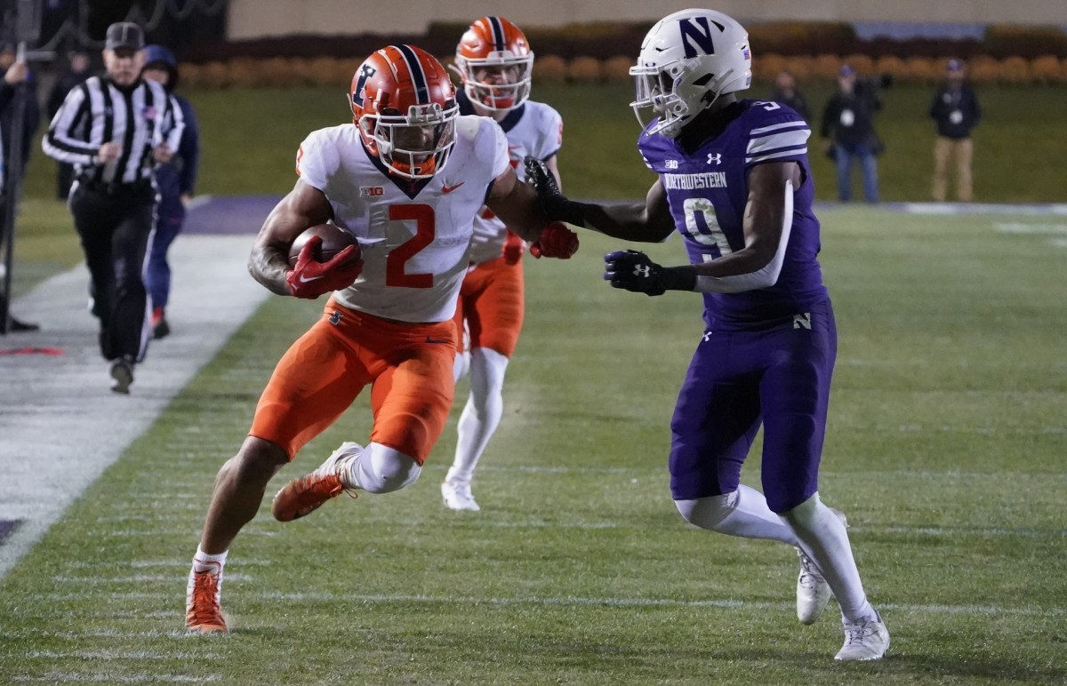 Illinois Illinois Fighting Illini running back Chase Brown (2) runs the ball against Northwestern defensive back Tyson Rooks (9). Mandatory Credit: David Banks-USA TODAY Sports