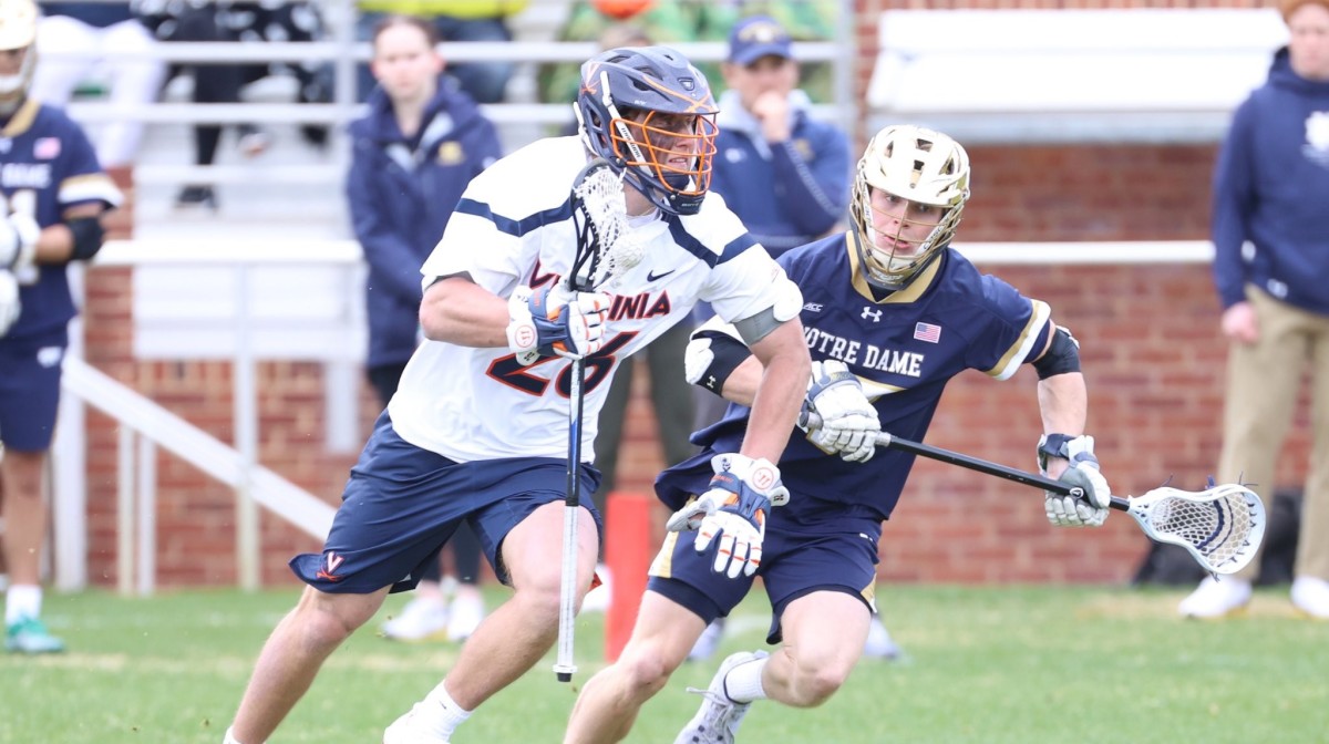 Griffin Schutz dodges with the ball during the Virginia men's lacrosse game against Notre Dame at Klockner Stadium.
