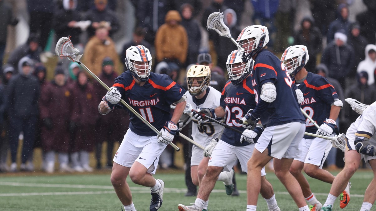 Cade Saustad collects a ground ball during the Virginia men's lacrosse game against Notre Dame at Arlotta Stadium.
