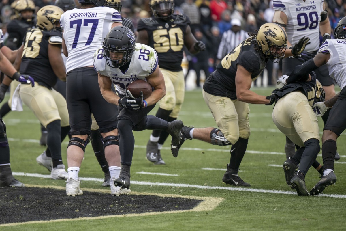 Nov 19, 2022; West Lafayette, Indiana, USA; Northwestern Wildcats running back Evan Hull (26) runs the ball in for a touchdown during the second half against the Purdue Boilermakers at Ross-Ade Stadium. Mandatory Credit: Marc Lebryk-USA TODAY Sports