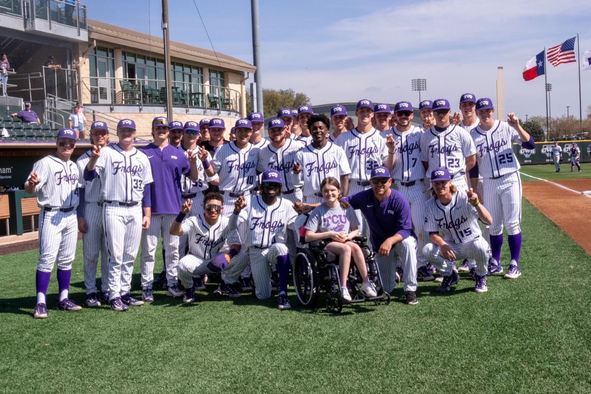 Abby Faber and the TCU baseball team after throwing out the first pitch