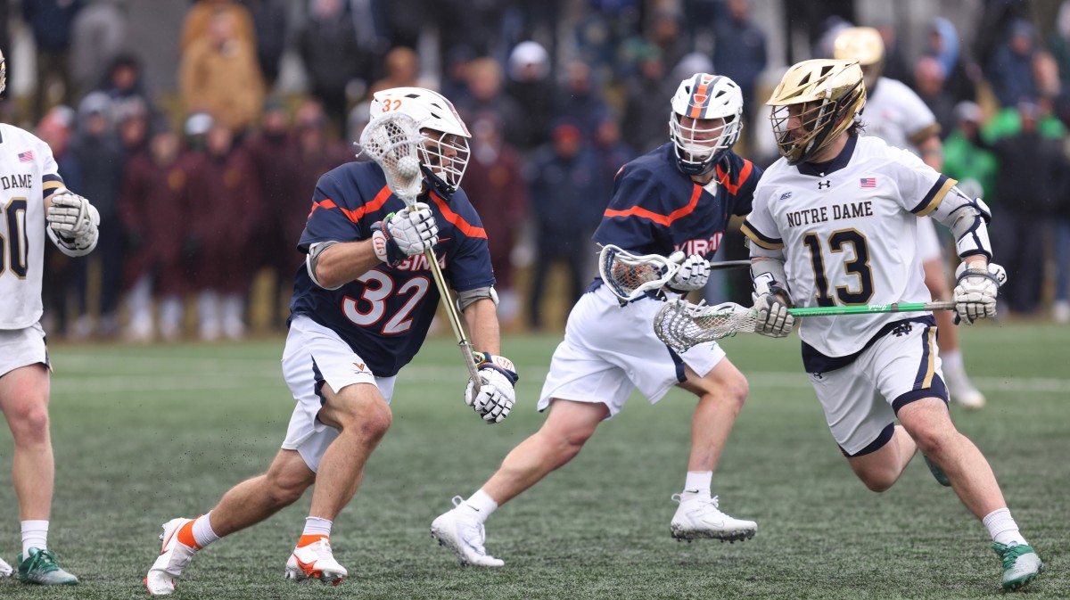 Grayson Sallade dodges with the ball during the Virginia men's lacrosse game against Notre Dame at Arlotta Stadium.