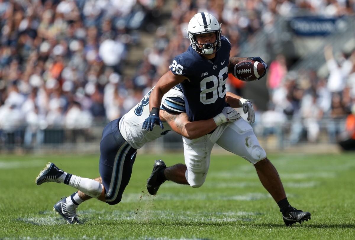 Sep 25, 2021; University Park, Pennsylvania, USA; Penn State Nittany Lions tight end Brenton Strange (86) runs with the ball while trying to avoid a tackle from Villanova Wildcats linebacker Forrest Rhyne (43) during the third quarter at Beaver Stadium. Penn State defeated Villanova 38-17. Mandatory Credit: Matthew OHaren-USA TODAY Sports