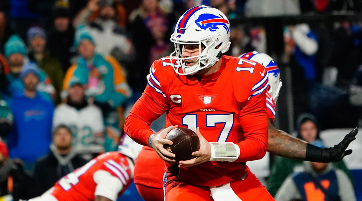 Josh Allen looks back to hand the ball off during a play