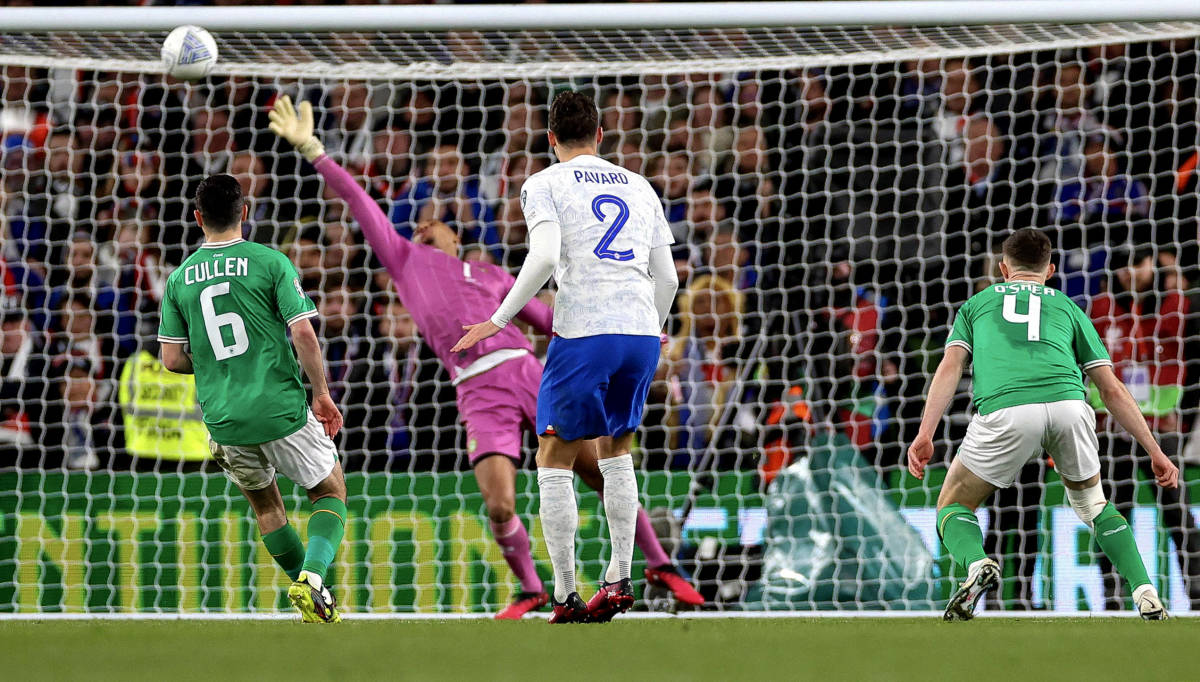 France defender Benjamin Pavard (center) pictured watching on as his shot beats Ireland goalkeeper Gavin Bazunu during a Euro 2024 qualifier in March 2023