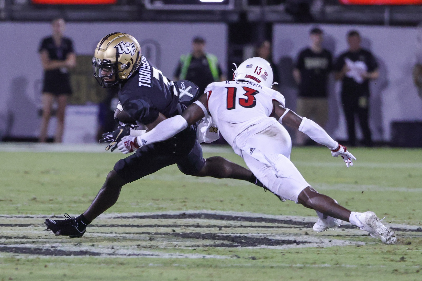 Sep 9, 2022; Orlando, Florida, USA; UCF Knights wide receiver Xavier Townsend (3) carries the ball against Louisville Cardinals defensive back Kei'Trel Clark (13) during the second quarter at FBC Mortgage Stadium. Mandatory Credit: Mike Watters-USA TODAY Sports