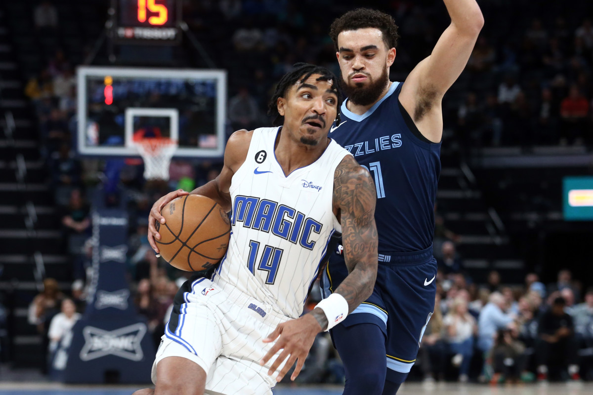 Mar 28, 2023; Memphis, Tennessee, USA; Orlando Magic guard Gary Harris (14) drives to the basket as Memphis Grizzlies guard Tyus Jones (21) defends during the first half at FedExForum. Mandatory Credit: Petre Thomas-USA TODAY Sports
