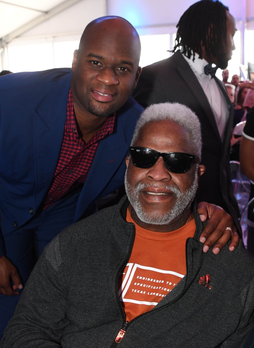 Earl Campbell (seated) and former Tennessee Titans quarterback Vince Young.  