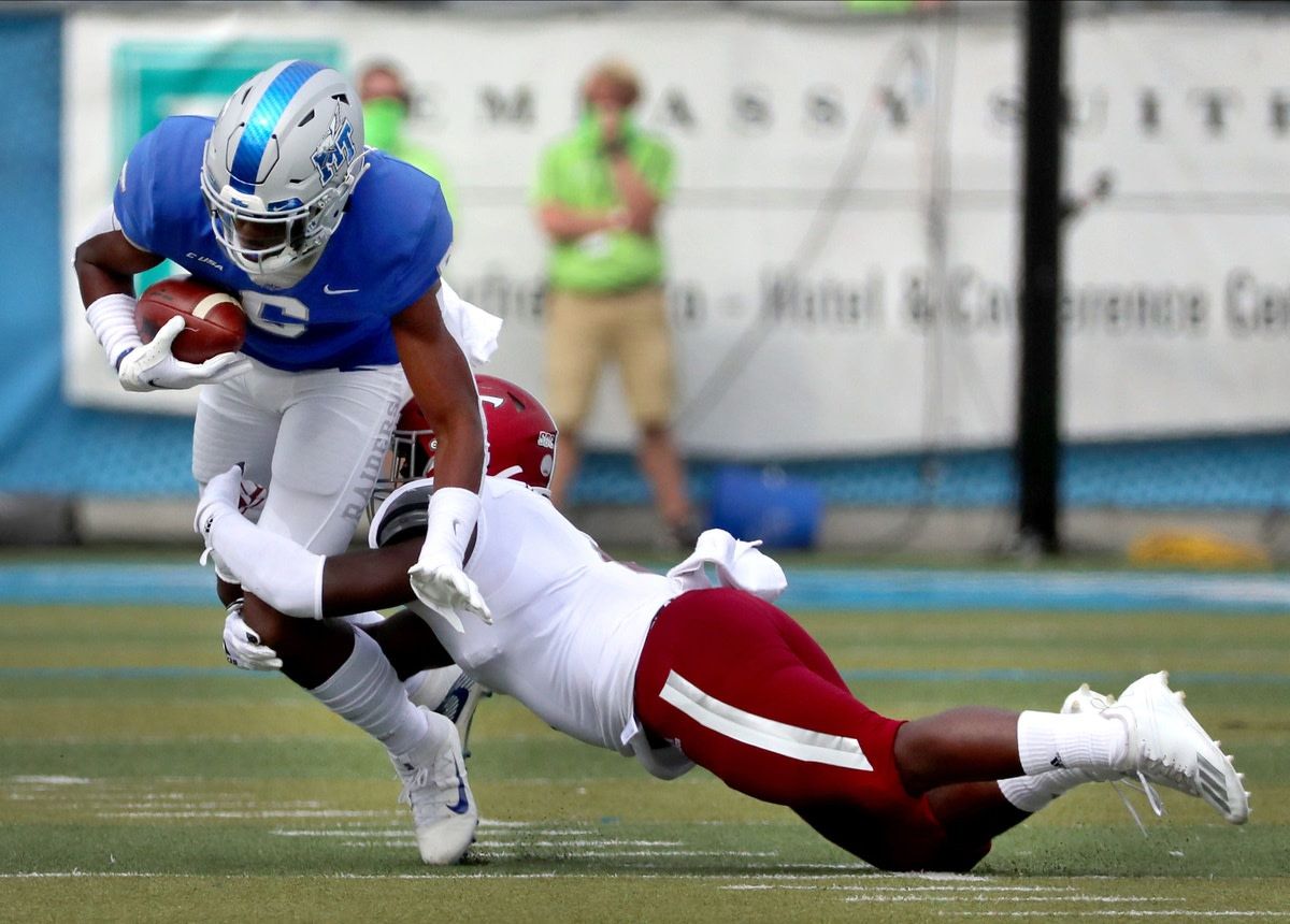 MTSU wide receiver Jimmy Marshall (6) runs the ball as Troy linebacker Carlton Martial (2) makes a diving tackle on Saturday, Sept. 19, 2020 at MTSU. 50 Mtsu V Troy