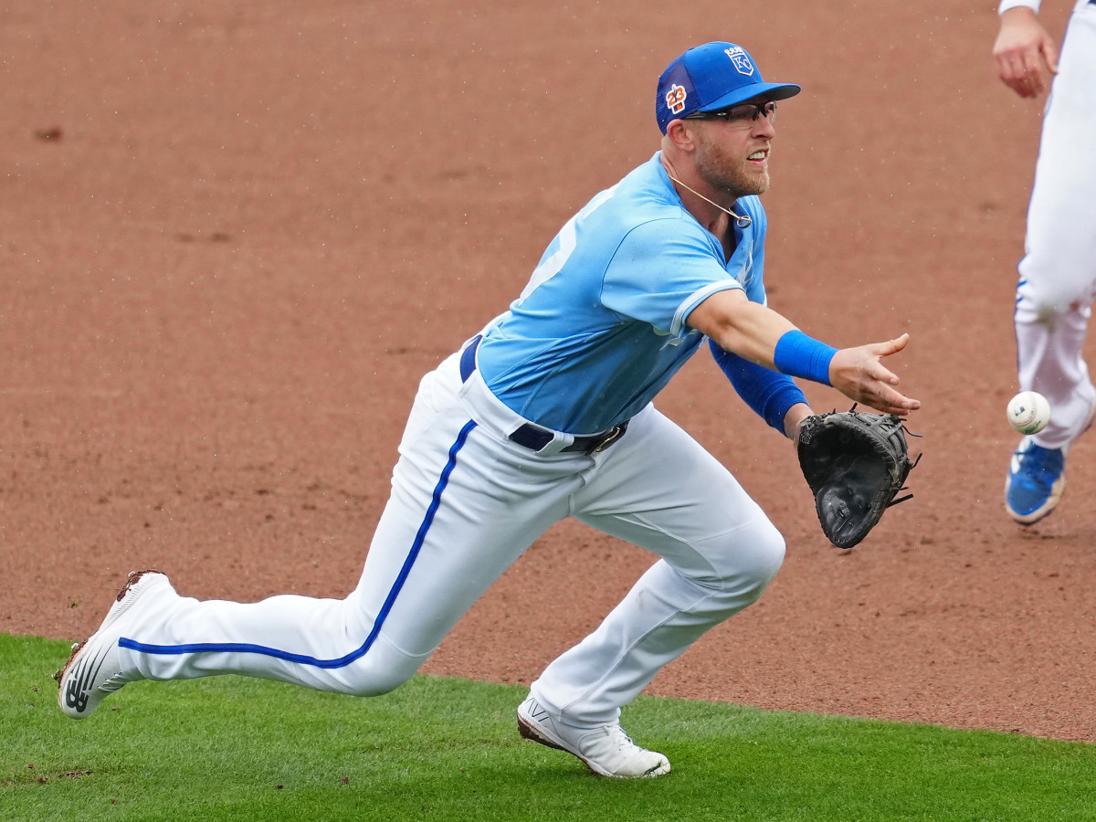 Kansas City Royals first baseman/outfielder Matt Beaty lobs the ball to first base during spring training. (2023)