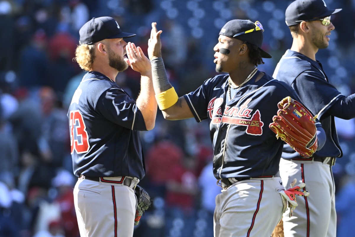 Mar 30, 2023; Washington, District of Columbia, USA; Atlanta Braves right fielder Ronald Acuna Jr. (13) and relief pitcher A.J. Minter (33) celebrate after the game against the Washington Nationals at Nationals Park. Mandatory Credit: Brad Mills-USA TODAY Sports
