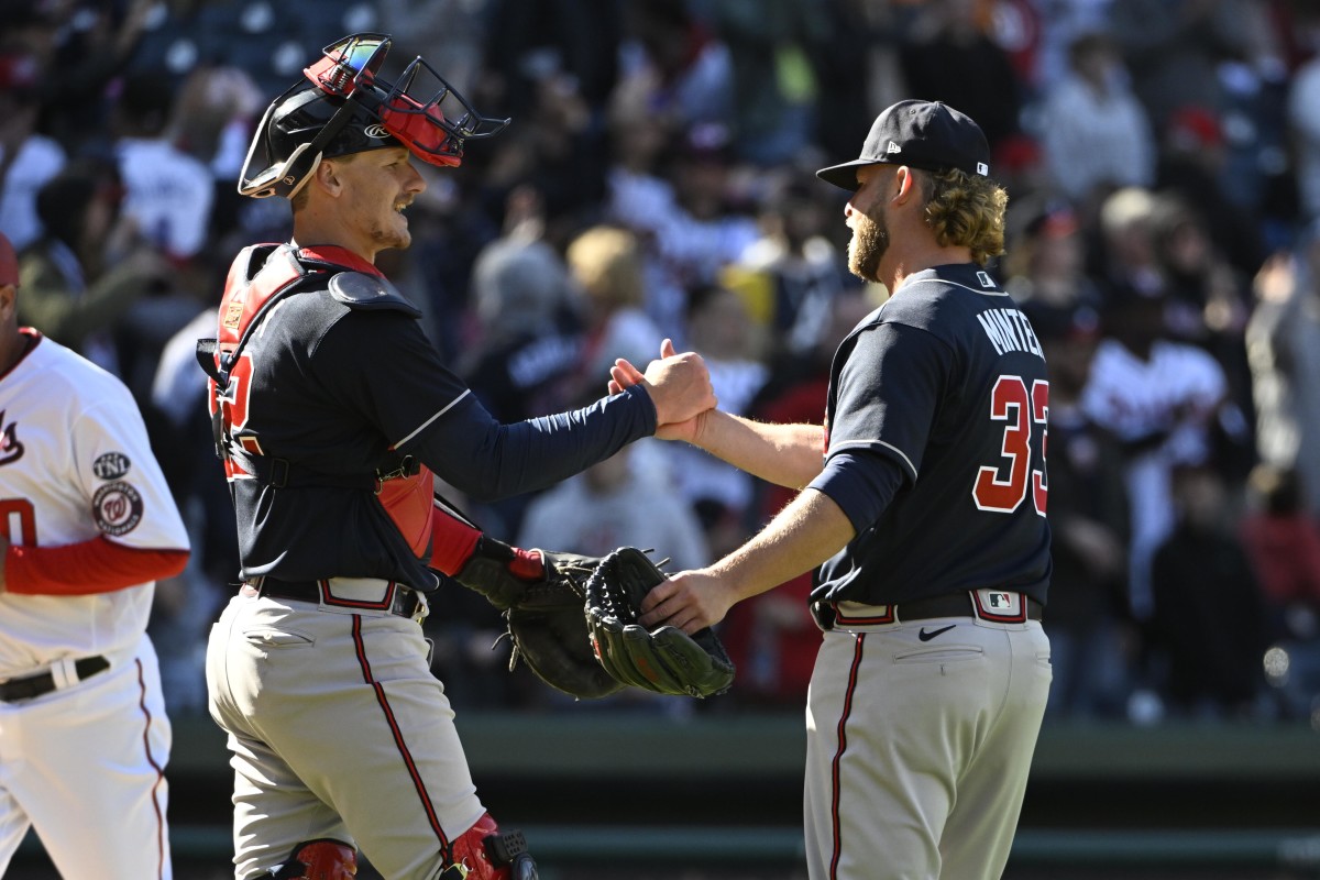 Mar 30, 2023; Washington, District of Columbia, USA; Atlanta Braves relief pitcher A.J. Minter (33) and catcher Sean Murphy (12) celebrate after the game against the Washington Nationals at Nationals Park. Mandatory Credit: Brad Mills-USA TODAY Sports
