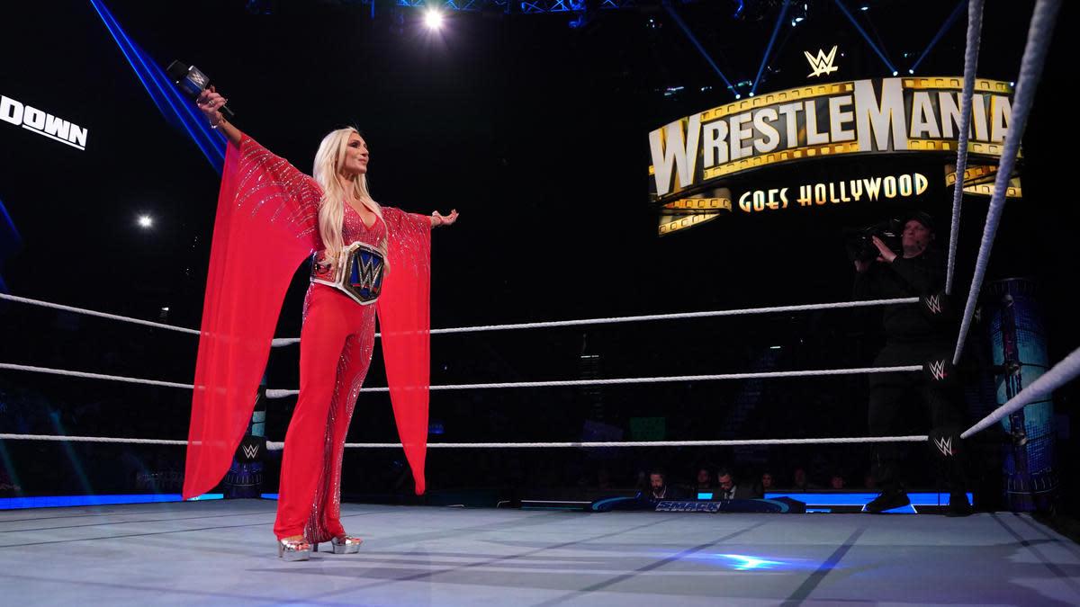 Charlotte Flair poses in the ring on SmackDown with the WrestleMania sign in the background