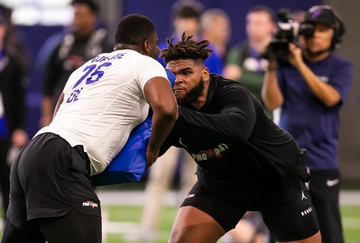 Florida Gators offensive lineman O'Cyrus Torrence (54), left, runs a blocking drill with offensive lineman Richard Gouraige (76) during the Gators 2023 Pro Day. © Doug Engle / USA TODAY NETWORK