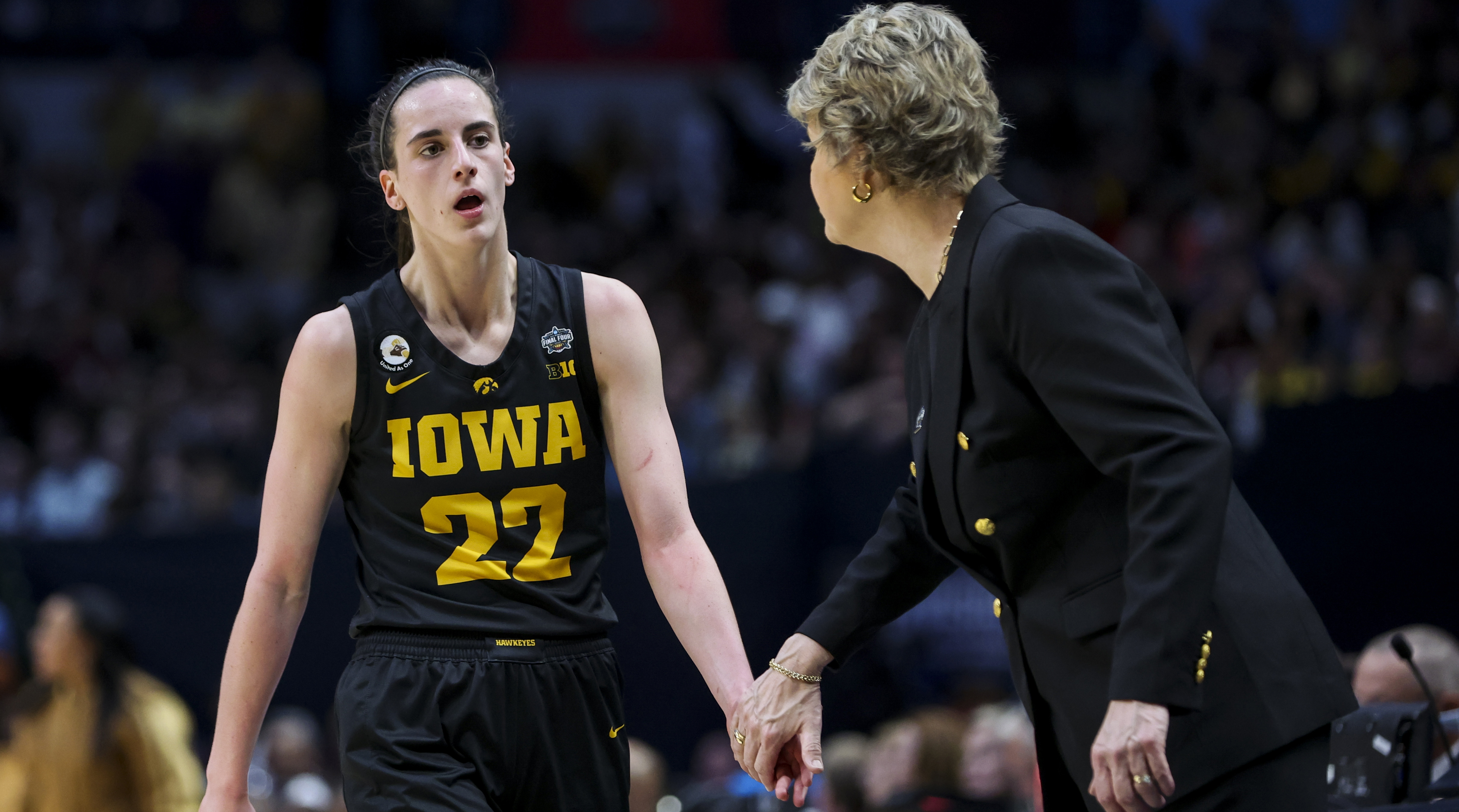 Iowa guard Caitlin Clark low-fives head coach Lisa Bluder during the Hawkeyes’ Final Four matchup against South Carolina.