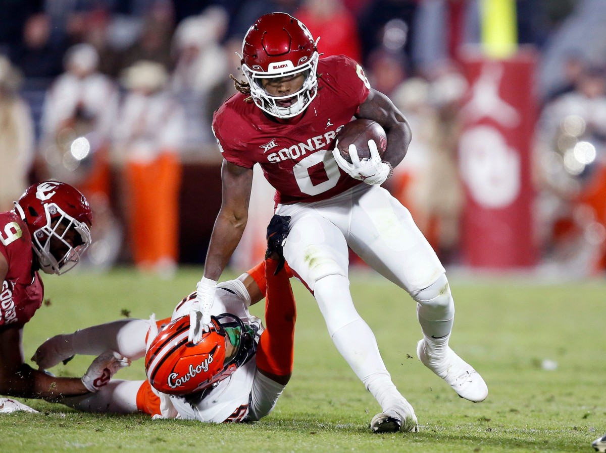 Oklahoma's Eric Gray (0) gets by Oklahoma State's Jason Taylor II (25) in the first half during the Bedlam college football game between the University of Oklahoma Sooners (OU) and the Oklahoma State University Cowboys (OSU) at Gaylord Family-Oklahoma Memorial Stadium, in Norman, Okla., Saturday, Nov., 19, 2022. Presto Id
