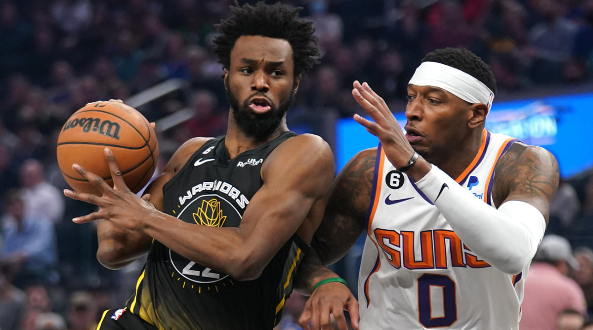 Warriors’ Andrew Wiggins drives past Suns’ Torrey Craig.